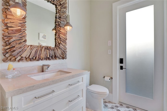 bathroom featuring vanity and toilet