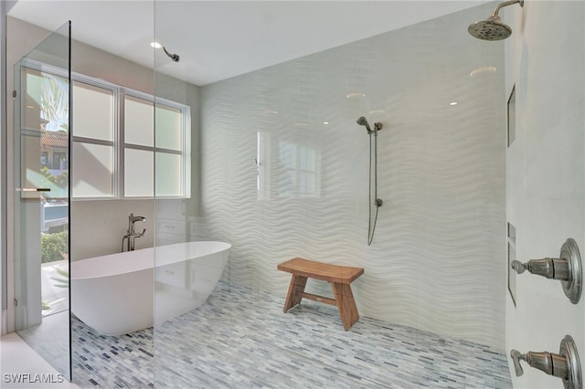 full bath with a walk in shower and a freestanding bath