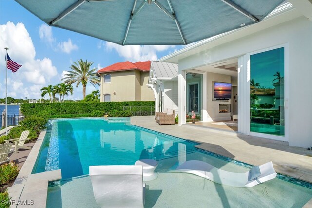 view of swimming pool featuring a patio area and fence