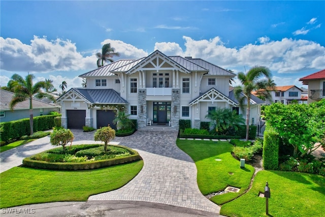 view of front of house with a garage and a front lawn