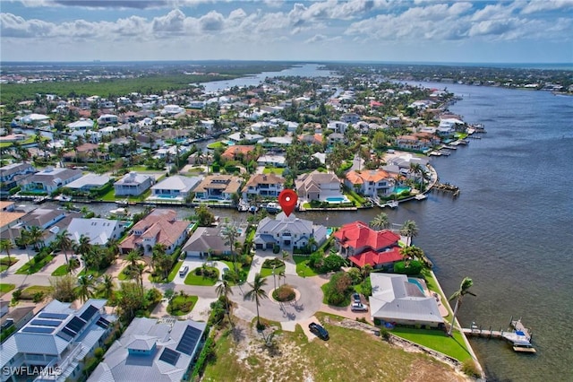 aerial view of residential area featuring a nearby body of water