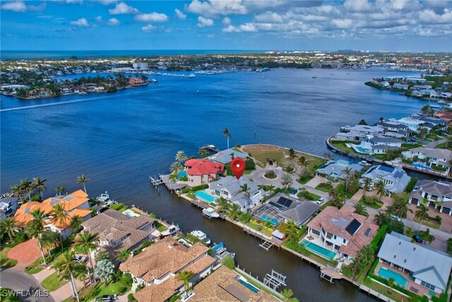 aerial perspective of suburban area with a nearby body of water