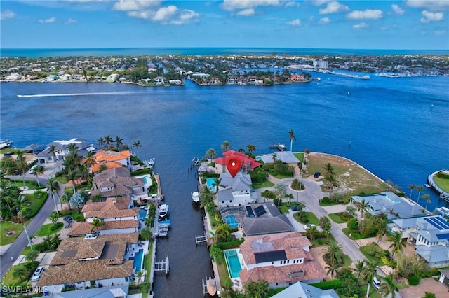 aerial view of residential area with a large body of water