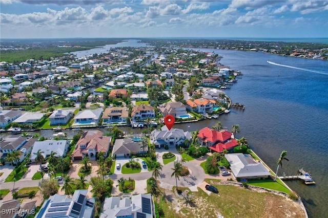 aerial view of property's location featuring nearby suburban area and a large body of water