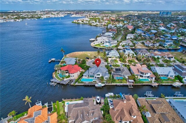 aerial view of property's location featuring a large body of water and nearby suburban area