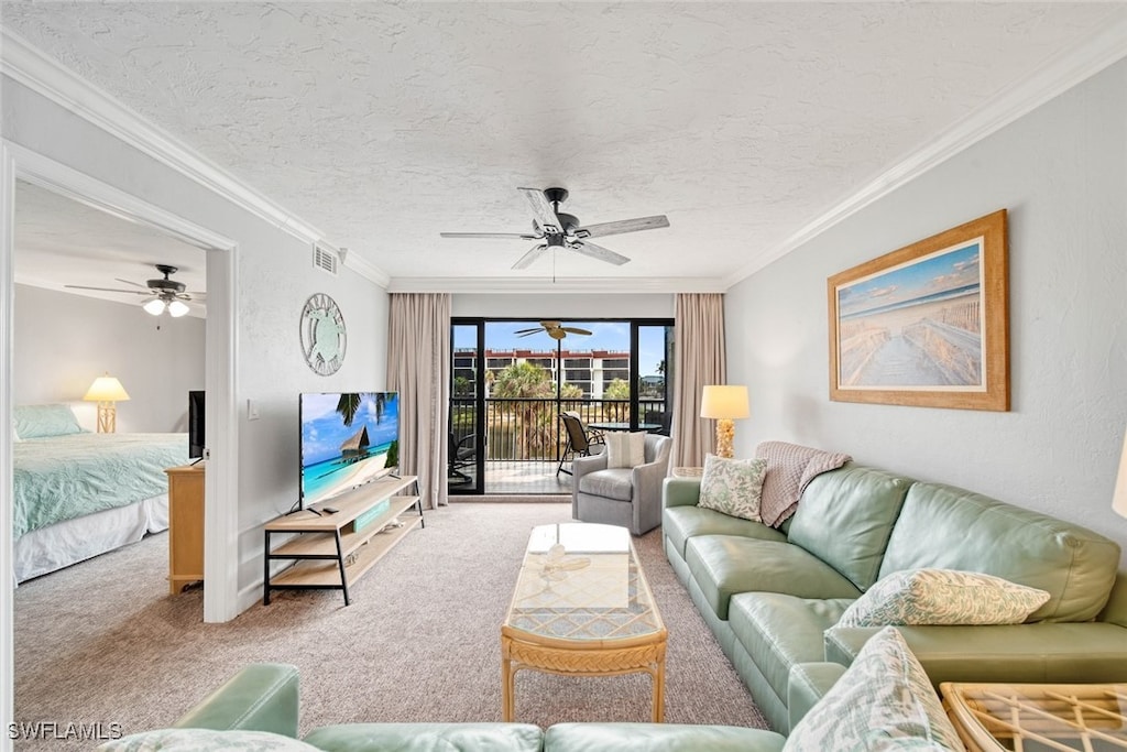 living room with ornamental molding, a textured ceiling, carpet flooring, and ceiling fan