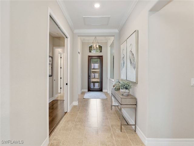 entryway with ornamental molding and light tile patterned floors