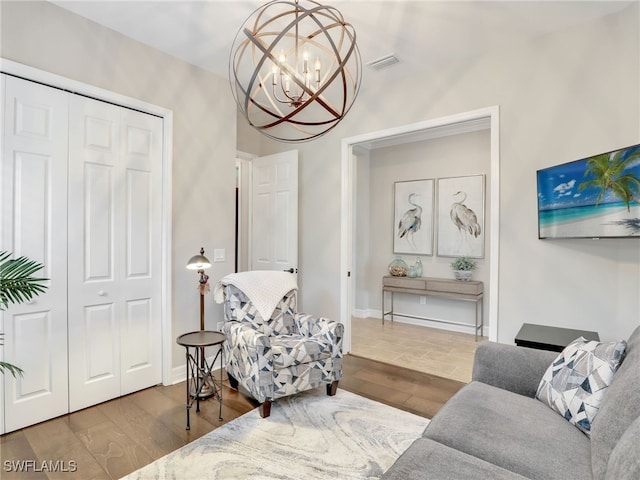 living area featuring an inviting chandelier and dark hardwood / wood-style floors