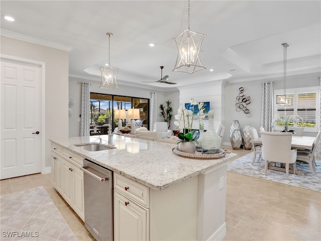 kitchen featuring a center island with sink, light stone counters, dishwasher, pendant lighting, and sink