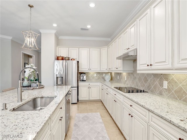 kitchen featuring sink, white cabinets, light stone counters, and pendant lighting