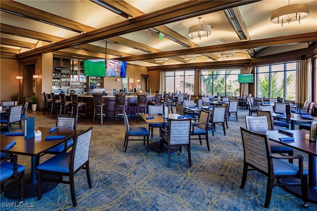 carpeted dining space featuring ornamental molding