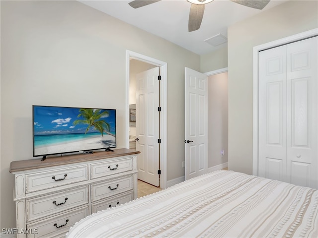 bedroom featuring light tile patterned floors, a closet, and ceiling fan