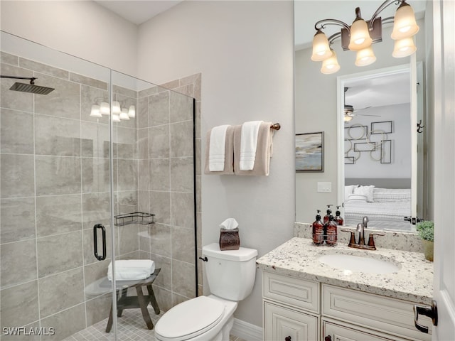 bathroom featuring vanity, an enclosed shower, toilet, and ceiling fan