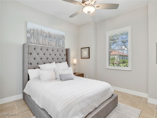 tiled bedroom featuring ceiling fan