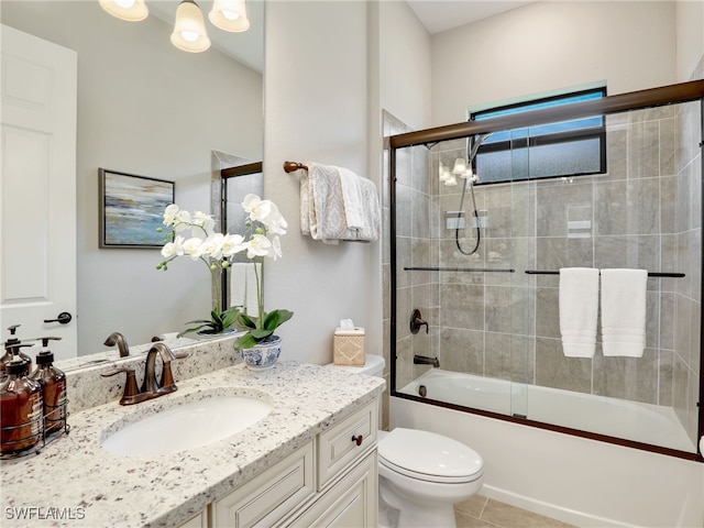 full bathroom with vanity, shower / bath combination with glass door, toilet, and tile patterned floors