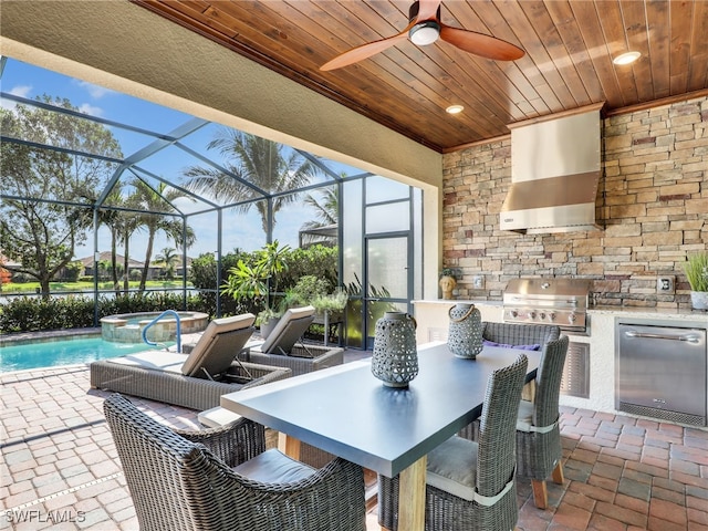 view of patio featuring an outdoor kitchen, ceiling fan, area for grilling, and a lanai