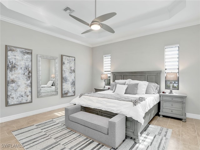 bedroom featuring crown molding, a raised ceiling, and ceiling fan