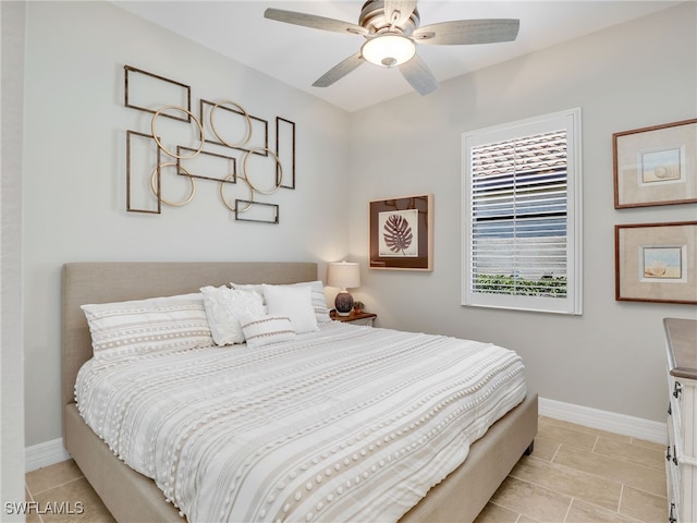 tiled bedroom featuring ceiling fan