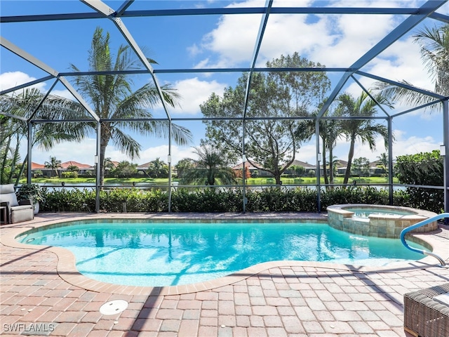 view of pool with a patio area, an in ground hot tub, and glass enclosure