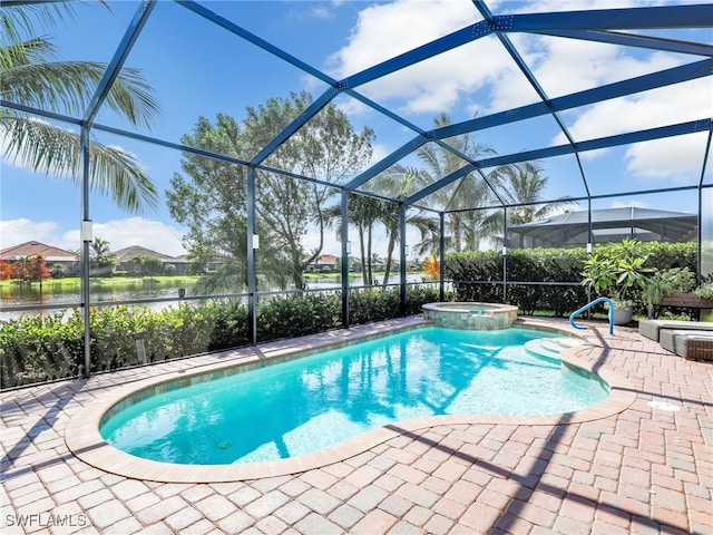 view of swimming pool featuring an in ground hot tub, a patio, a water view, and glass enclosure