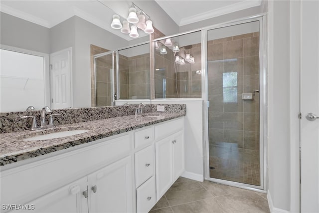 bathroom with vanity, an enclosed shower, tile patterned floors, and crown molding