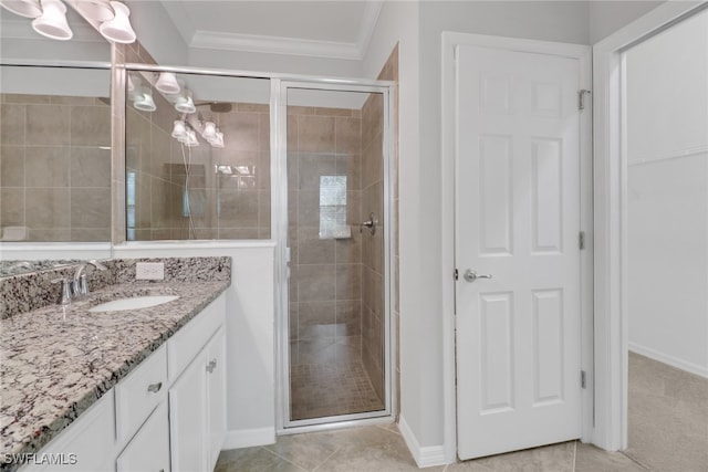 bathroom featuring vanity, ornamental molding, tile patterned flooring, and a shower with door