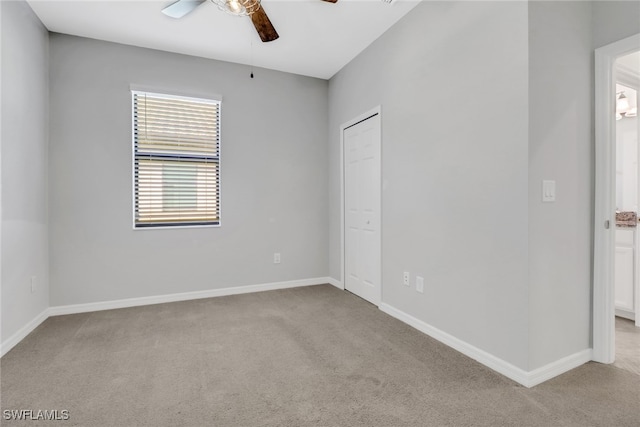 empty room featuring light carpet and ceiling fan