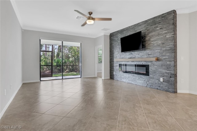 unfurnished living room featuring a stone fireplace, ornamental molding, and ceiling fan