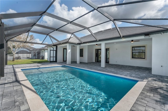 view of swimming pool featuring a patio area, a lanai, and ceiling fan