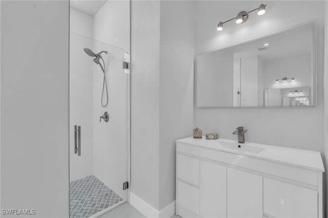 bathroom featuring vanity and a shower with shower door