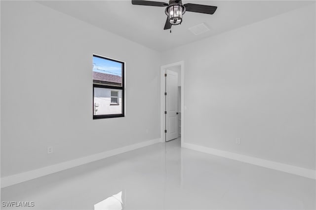 spare room featuring ceiling fan and light tile patterned flooring