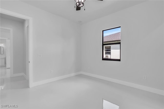 spare room featuring ceiling fan and tile patterned flooring