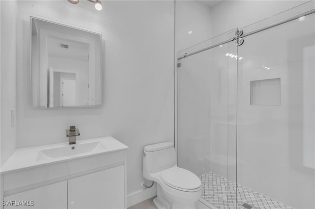 bathroom featuring a shower with door, toilet, and vanity