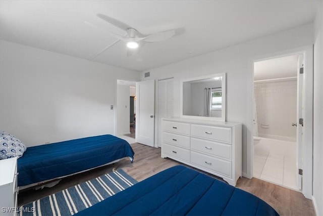 bedroom with ceiling fan, light hardwood / wood-style floors, connected bathroom, and a closet