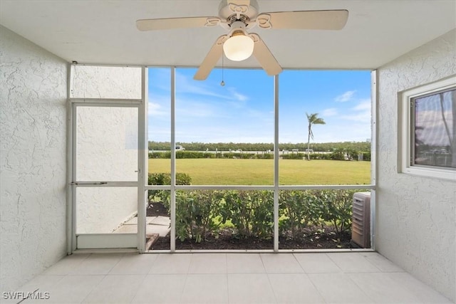 unfurnished sunroom with a wealth of natural light and ceiling fan