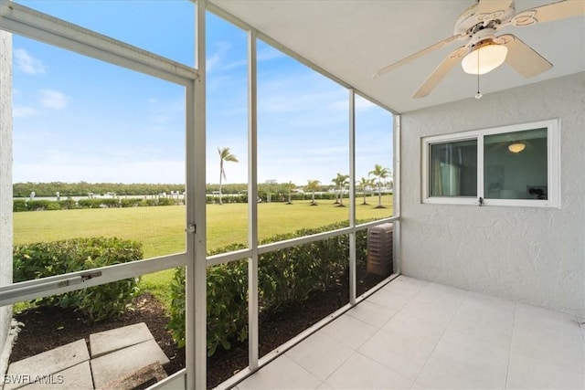 unfurnished sunroom featuring ceiling fan