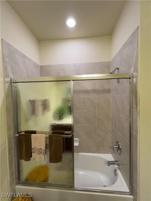 bathroom featuring combined bath / shower with glass door