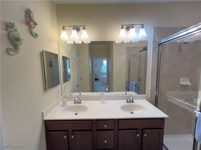 bathroom with vanity and a shower with door