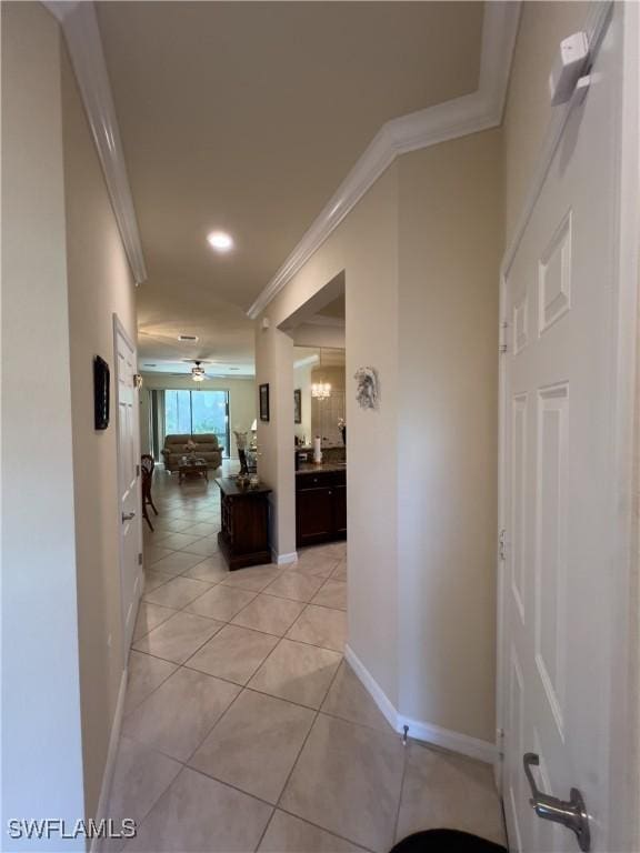 hall featuring ornamental molding and light tile patterned floors