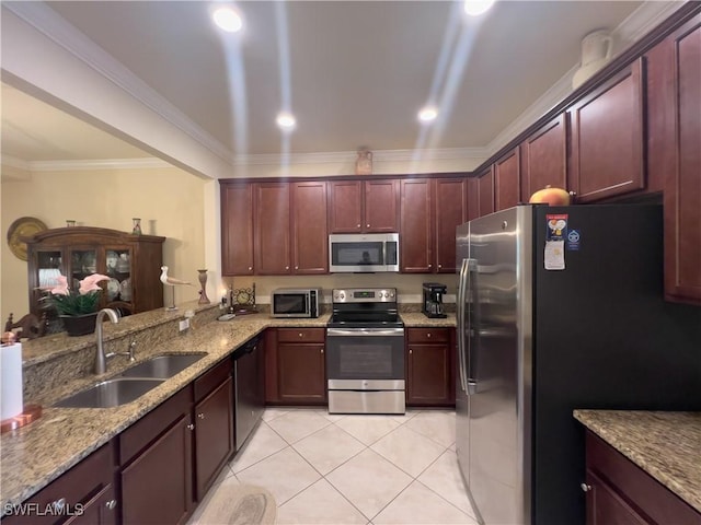 kitchen with sink, light tile patterned floors, appliances with stainless steel finishes, light stone countertops, and kitchen peninsula