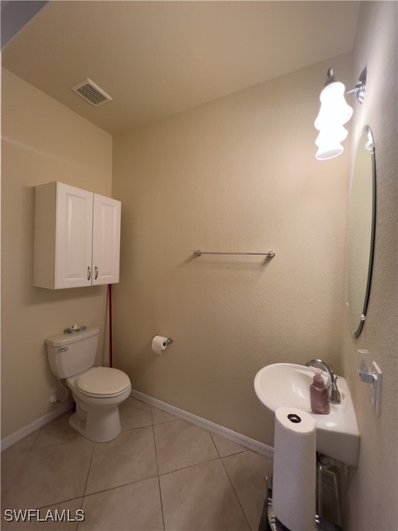 bathroom with tile patterned floors and toilet