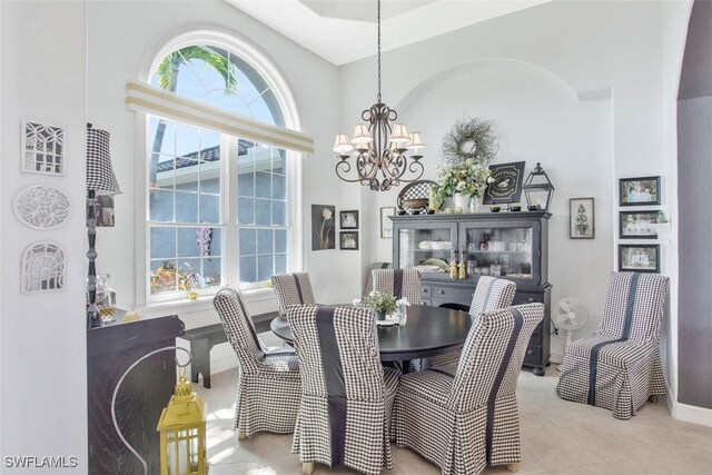 dining space featuring a notable chandelier, light tile patterned floors, and a healthy amount of sunlight