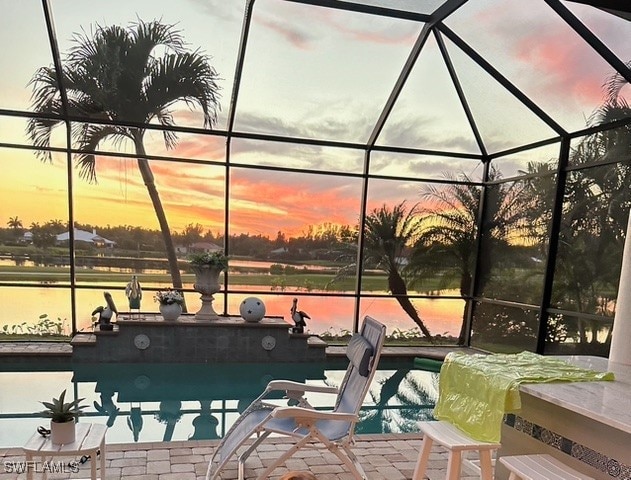 exterior space featuring a water view, a patio area, and a lanai