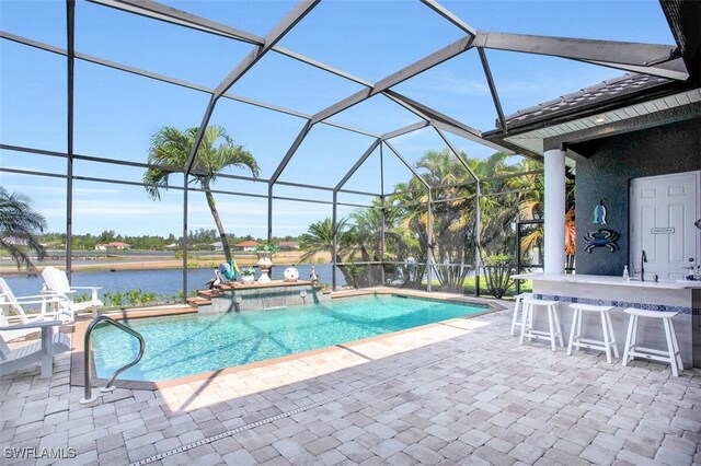 view of pool with a wet bar, a water view, glass enclosure, a patio area, and a hot tub