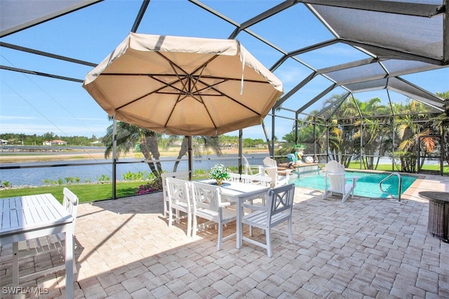 view of patio with a lanai and a water view