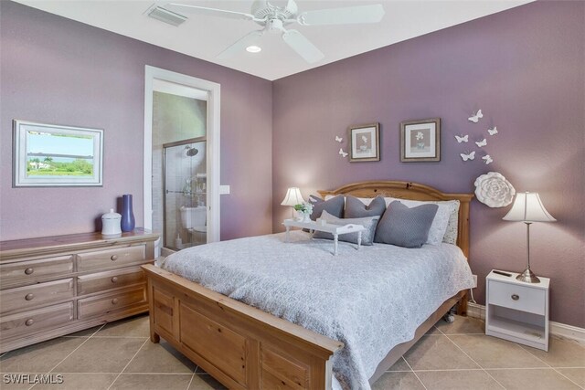 bedroom featuring connected bathroom, light tile patterned floors, and ceiling fan