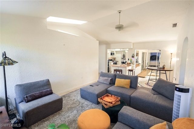 living room featuring ceiling fan, french doors, carpet, and vaulted ceiling