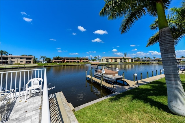 dock area featuring a water view and a yard