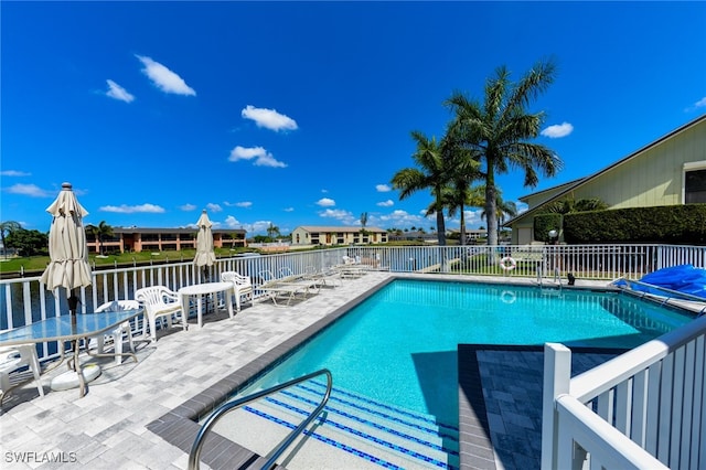 view of swimming pool featuring a patio