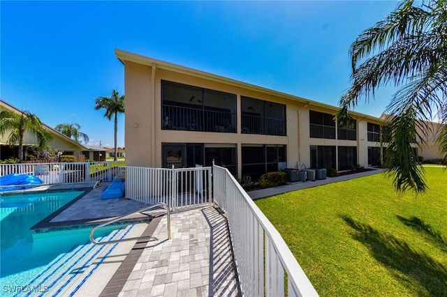 view of swimming pool featuring a yard and a patio area